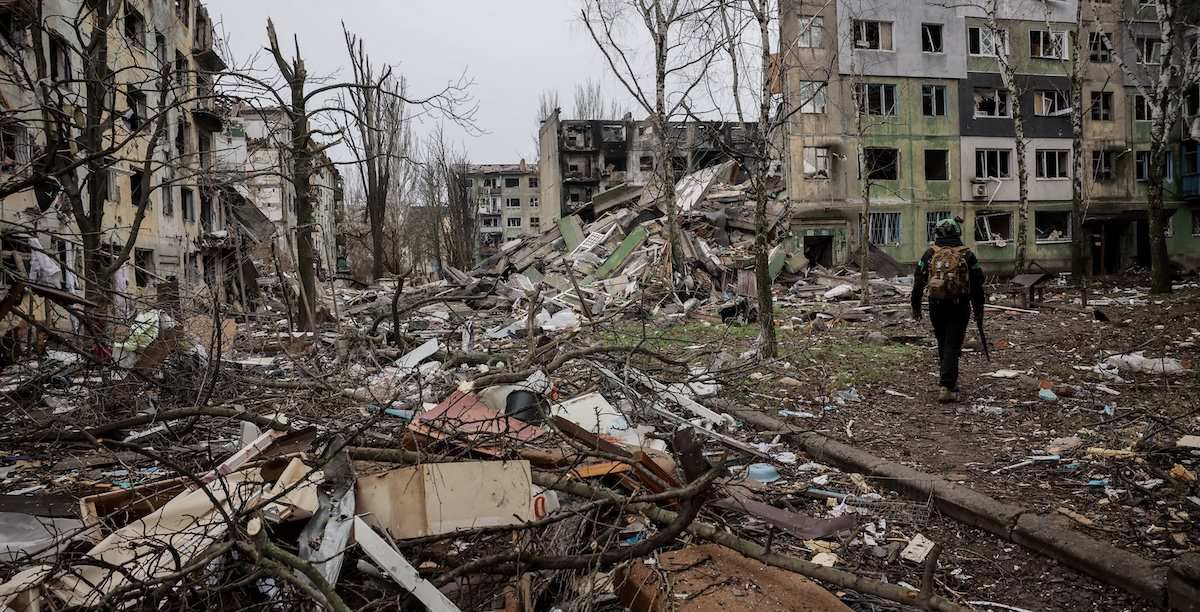​Ukrainian serviceman walks near apartment buildings damaged by Russian military strike, amid Russia's attack on Ukraine, in the frontline town of Kostiantynivka in Donetsk region, Ukraine December 20, 2025. 