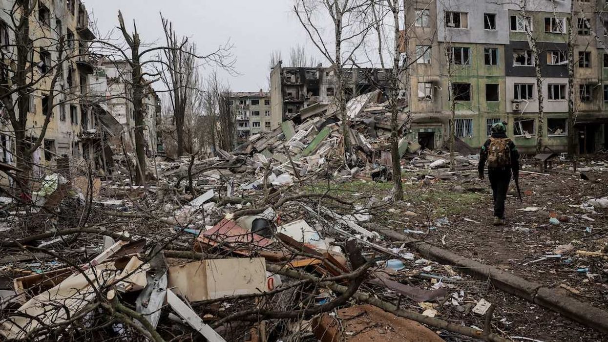Ukrainian serviceman walks near apartment buildings damaged by Russian military strike, amid Russia's attack on Ukraine, in the frontline town of Kostiantynivka in Donetsk region, Ukraine December 20, 2025.