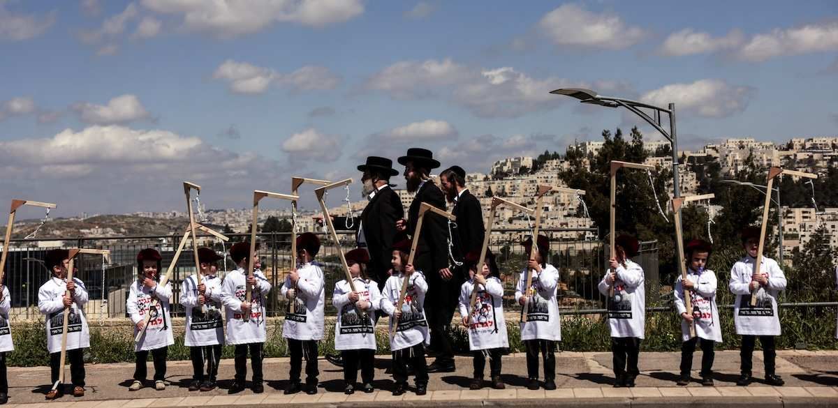 ​Ultra-Orthodox Jewish children hold makeshift gallows as part of a protest against attempts to change government policy that grants?ultra-Orthodox?Jews exemptions from military conscription, in Jerusalem, March 20, 2024. 