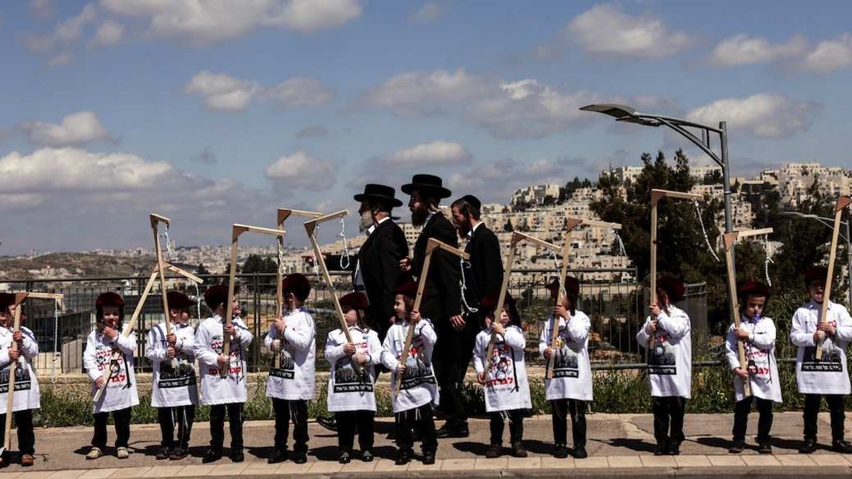 Ultra-Orthodox Jewish children hold makeshift gallows as part of a protest against attempts to change government policy that grants?ultra-Orthodox?Jews exemptions from military conscription, in Jerusalem, March 20, 2024.