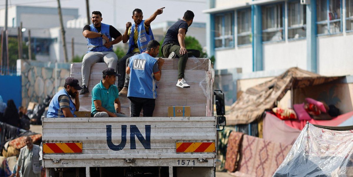 UN workers arrive to distribute aid to Palestinians, who have fled their homes due to Israeli strikes, in Khan Younis in southern Gaza on October 23, 2023.