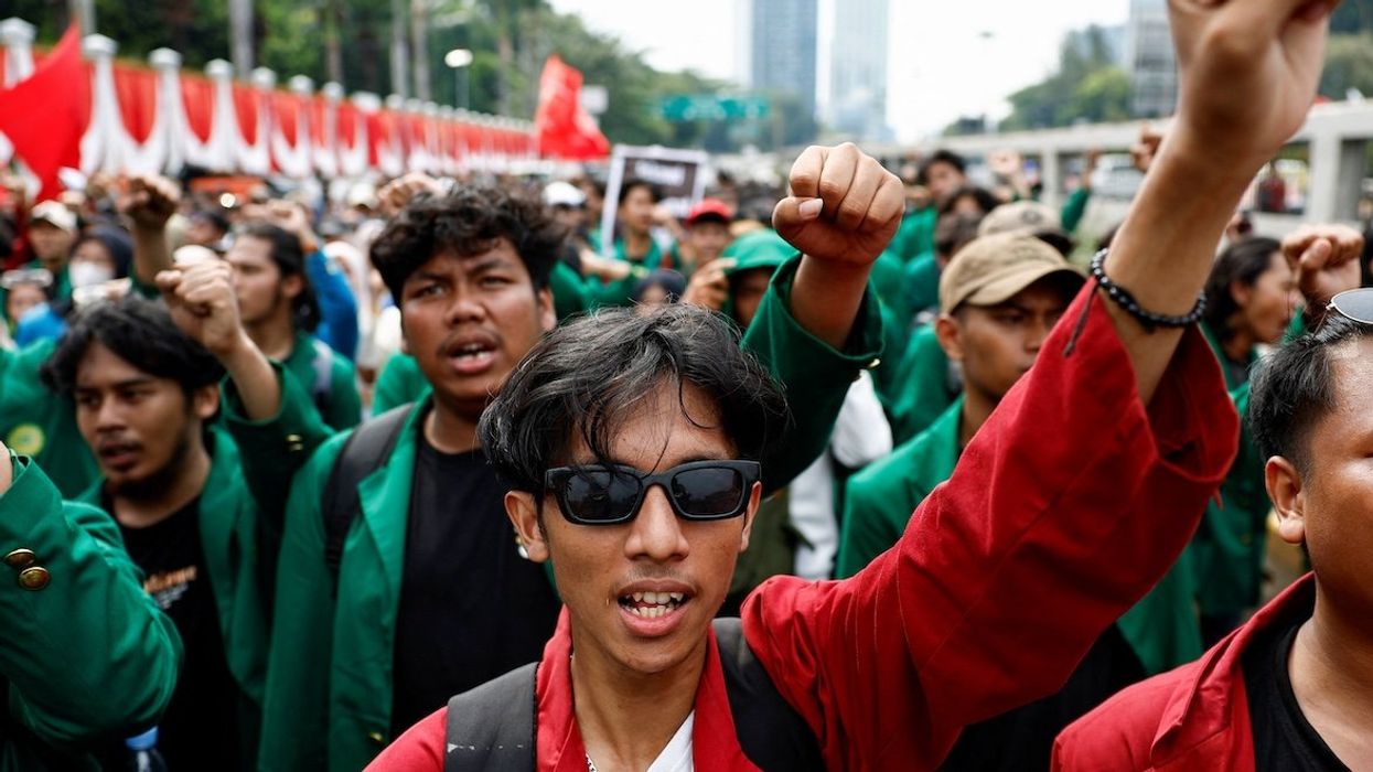 University students gesture as they shout slogans during a protest against planned controversial revisions to election law outside the Indonesian Parliament building in Jakarta, Indonesia, on Aug. 22, 2024.