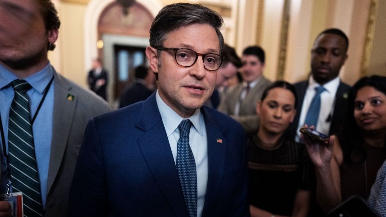 US House Speaker Mike Johnson talks with reporters in the US Capitol on May 8, 2025.