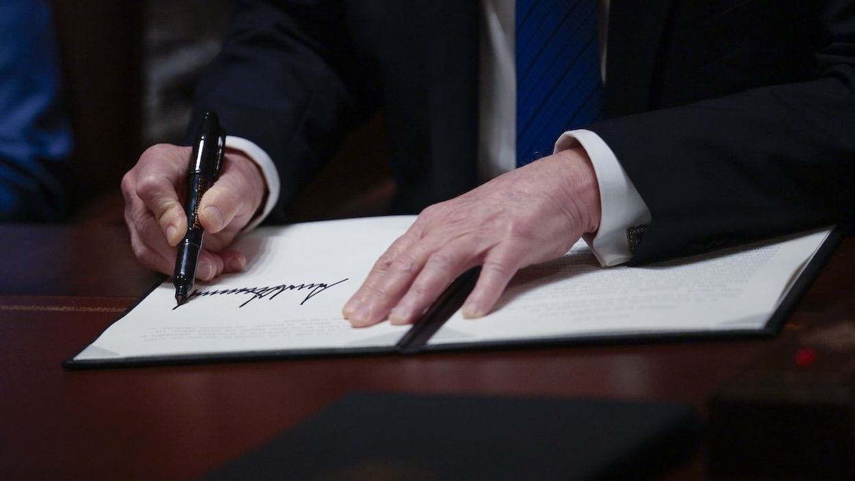 US President Donald J. Trump signs executive orders in the Cabinet Room of the White House on March 25, 2025.