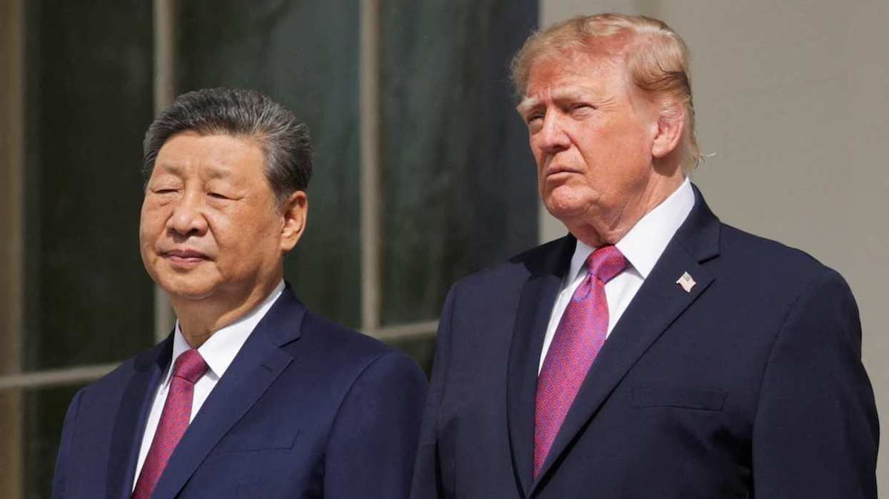 US President Donald Trump and Chinese President Xi Jinping watch a military demonstration from a balcony of the White House in Washington, D.C.