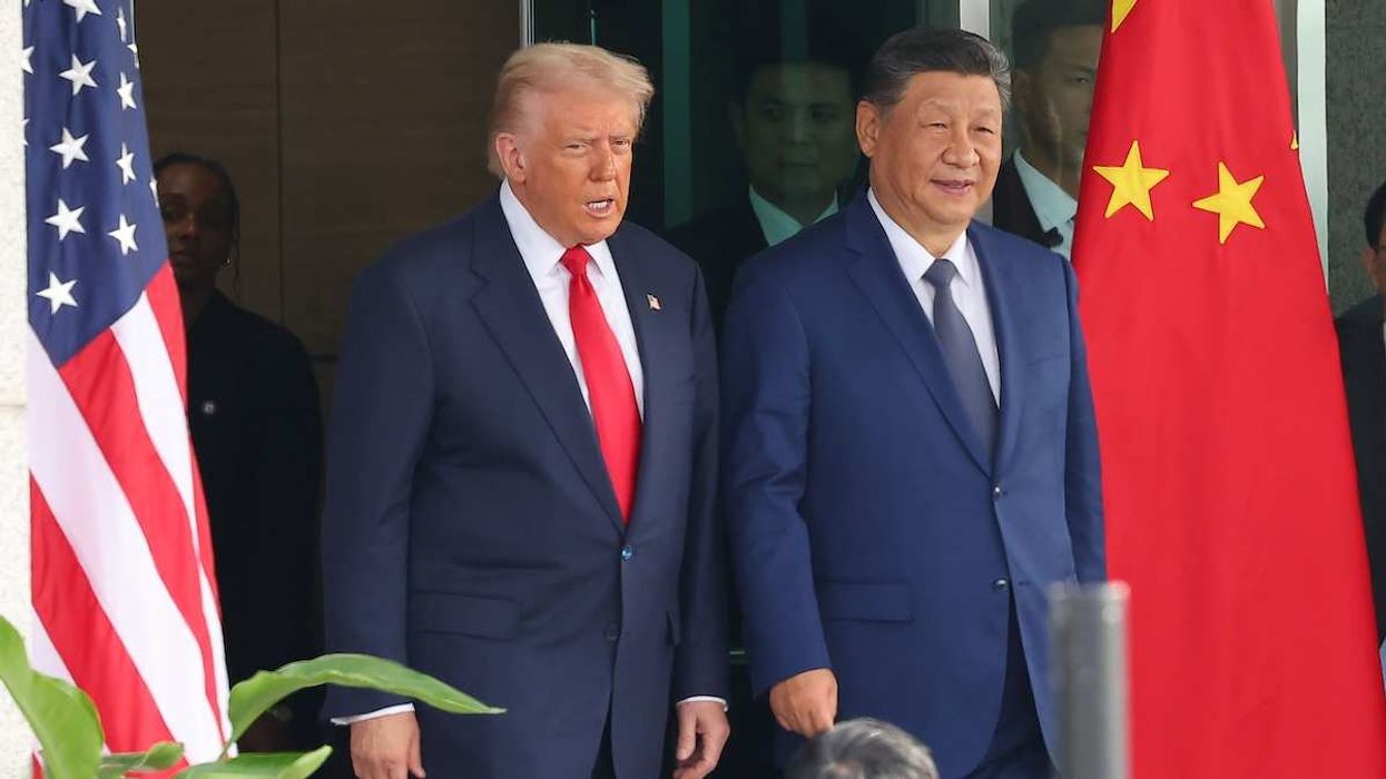 US President Donald Trump speaks with Chinese President Xi Jinping at Gimhae Air Base in Gimhae, South Korea, on October 30, 2025.