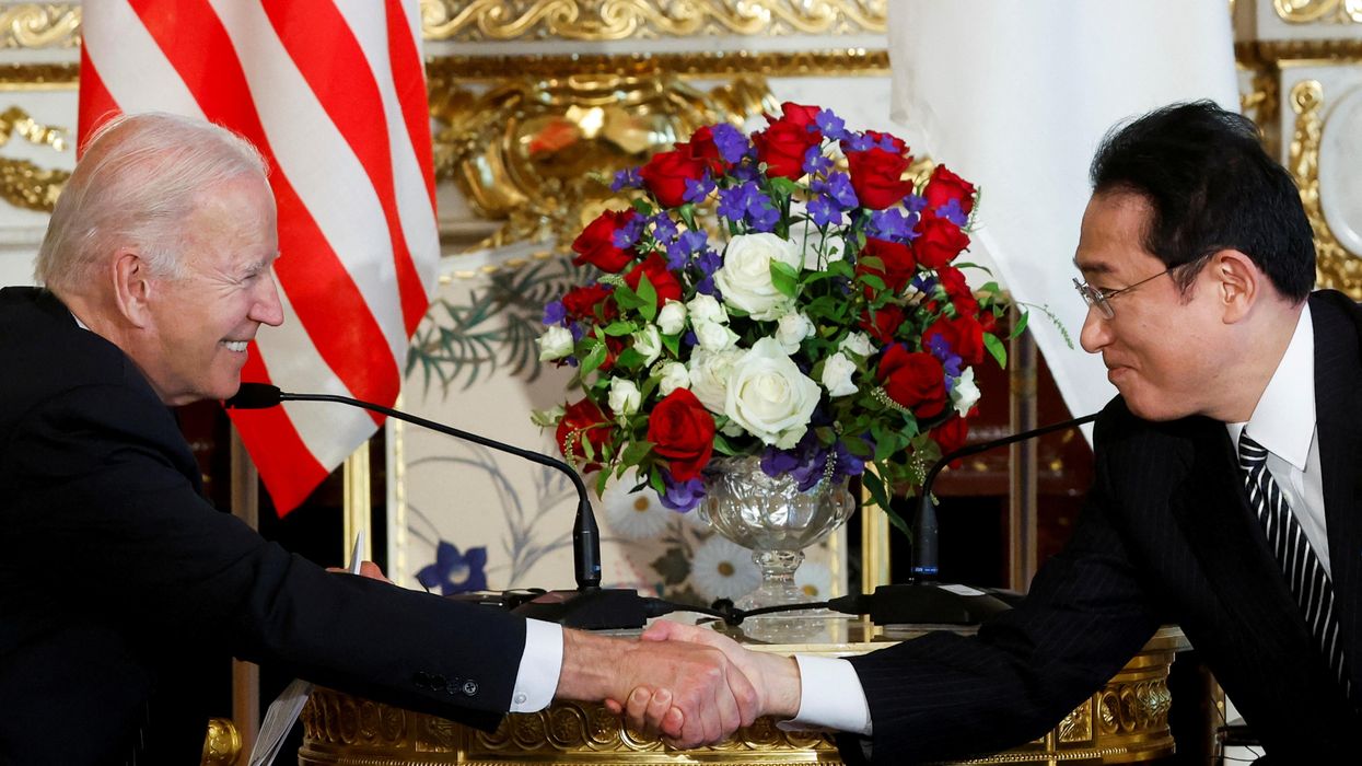 US President Joe Biden and Japan's Prime Minister Fumio Kishida shake hands as they attend a bilateral meeting at Akasaka Palace in Tokyo.