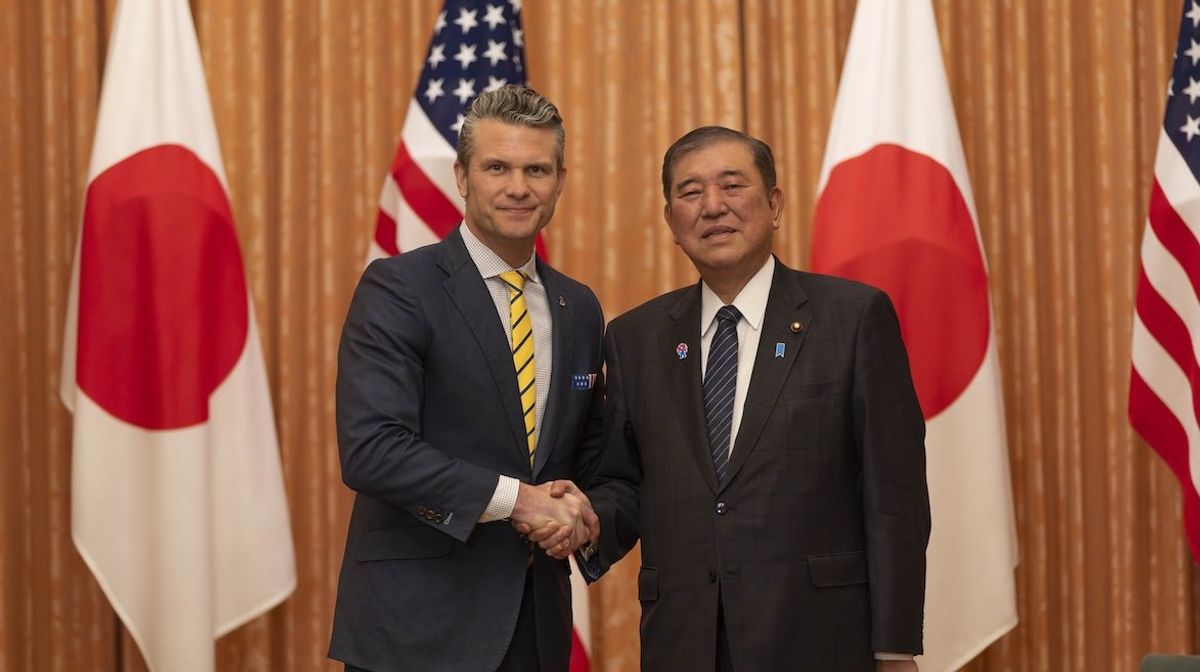 US Secretary of Defense Pete Hegseth shakes hands with Japanese Prime Minister Shigeru Ishiba at the Prime Minister's office in Tokyo on March 30, 2025. 