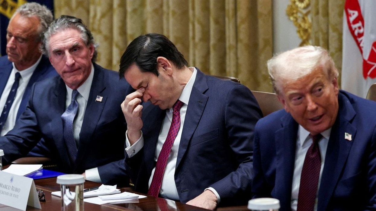 US Secretary of State Rubio rubs the bridge of his nose while sitting alongside US President Donald Trump during a Cabinet meeting at the White House on August 26, 2025.