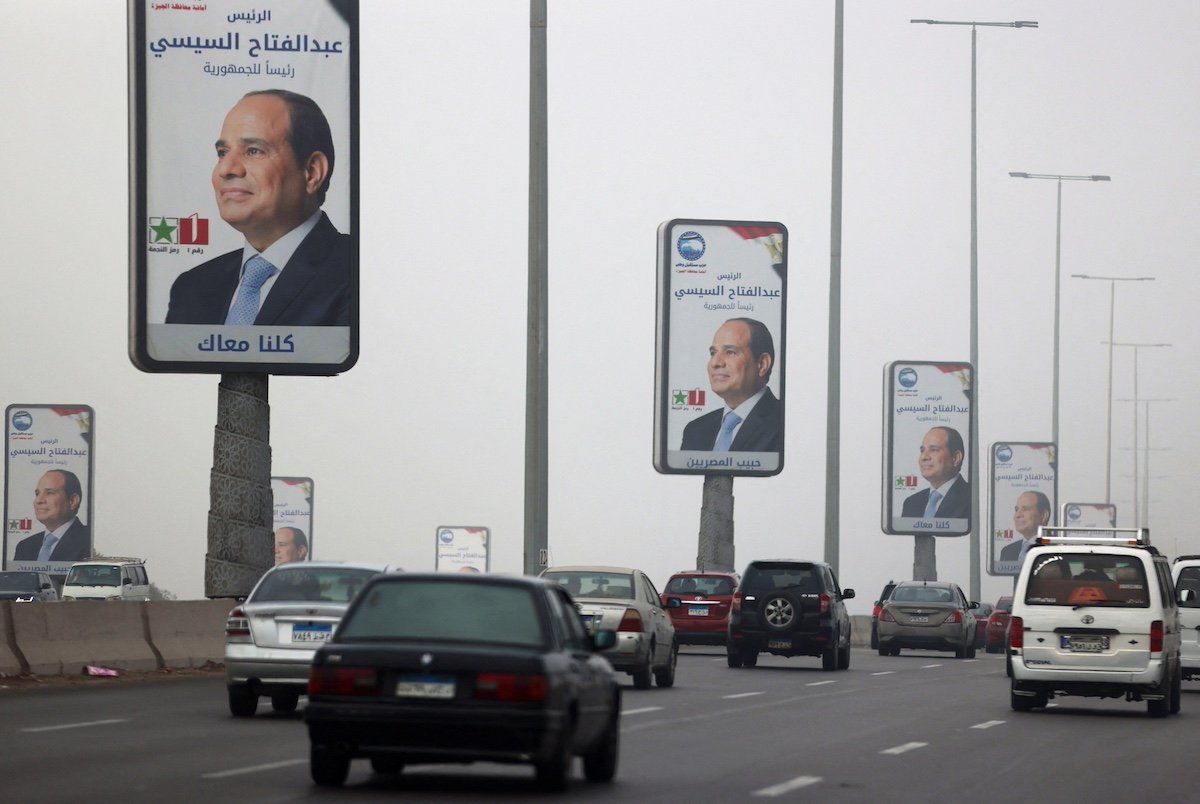 Vehicles drive past posters of presidential candidate and current Egyptian President Abdel Fattah al-Sisi ahead of the presidential elections to be held inside the country next week, in Cairo, Egypt, December 5, 2023.