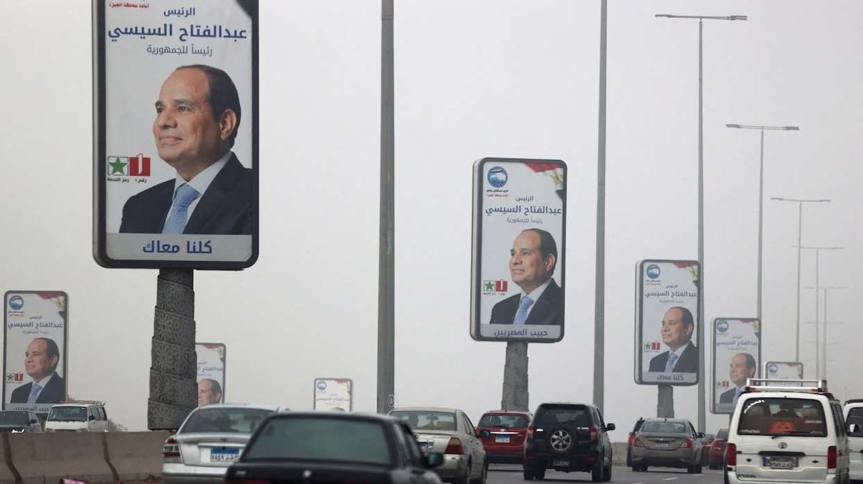 Vehicles drive past posters of presidential candidate and current Egyptian President Abdel Fattah al-Sisi ahead of the presidential elections to be held inside the country next week, in Cairo, Egypt, December 5, 2023.