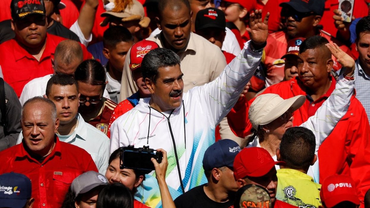 Venezuela's President Nicolas Maduro, his wife Cilia Flores, and Vice President of the United Socialist Party of Venezuela Diosdado Cabello participate in a rally during May Day celebrations in Caracas, Venezuela, on May 1, 2024.