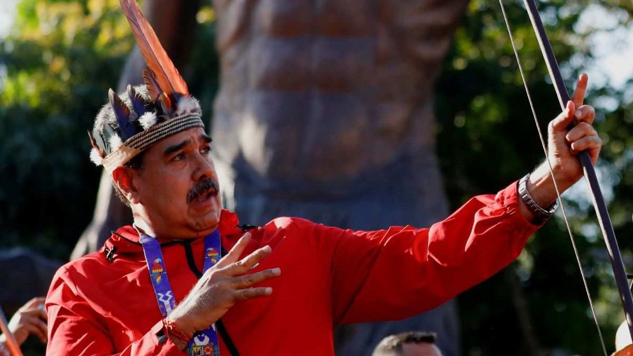 Venezuela's President Nicolas Maduro reacts after shooting an arrow during a rally on the Day of Indigenous Resistance in Caracas, Venezuela, on October 12, 2025.