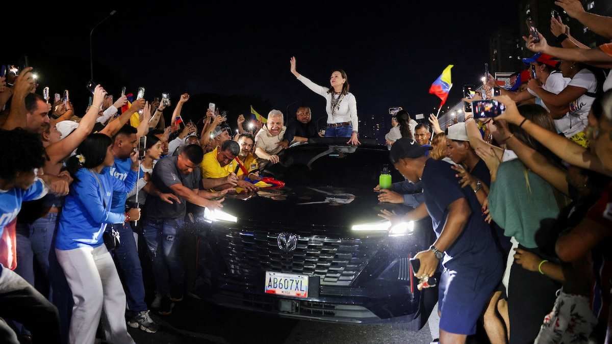 Venezuelan opposition leader Maria Corina Machado greets supporters after travelling from Barquisimeto, where she made her first public appearance following her return to the country after nearly a year abroad, in Caracas, Venezuela, October 25, 2026.