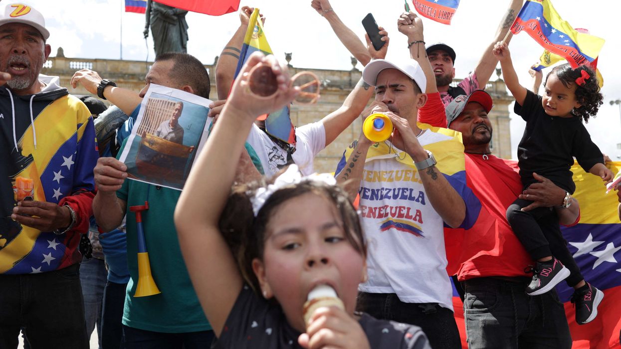 Venezuelans living in Colombia hold flags as they gather at Plaza de Bolivar to celebrate after U.S. President Donald Trump said the U.S. has struckVenezuela and captured its President Nicolas Maduro and his wife Cilia Flores, in Bogota, Colombia, January 3, 2026.
