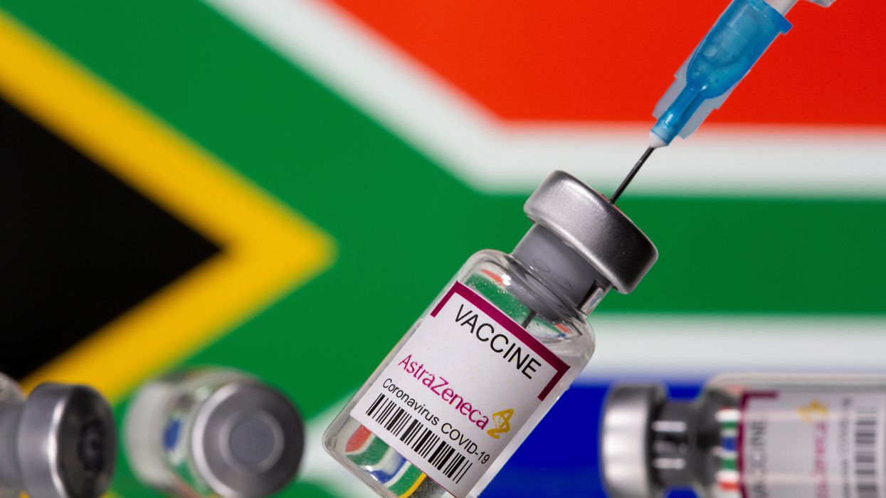 Vials labelled "Astra Zeneca COVID-19 Coronavirus Vaccine" and a syringe are seen in front of a displayed South Africa flag, in this illustration photo taken March 14, 2021.