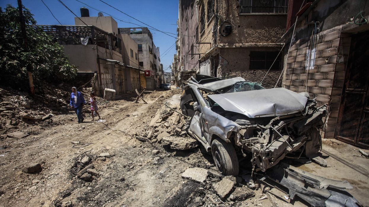 View of a destroyed car on the street caused by an Israeli airstrike on the city of Jenin in the northern occupied West Bank.