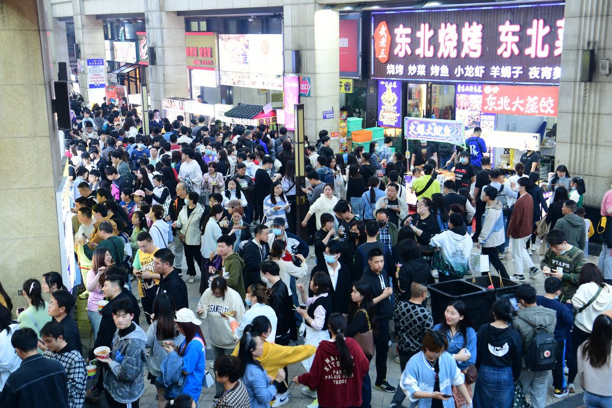 Visitors attend a night market in Shanghai, China