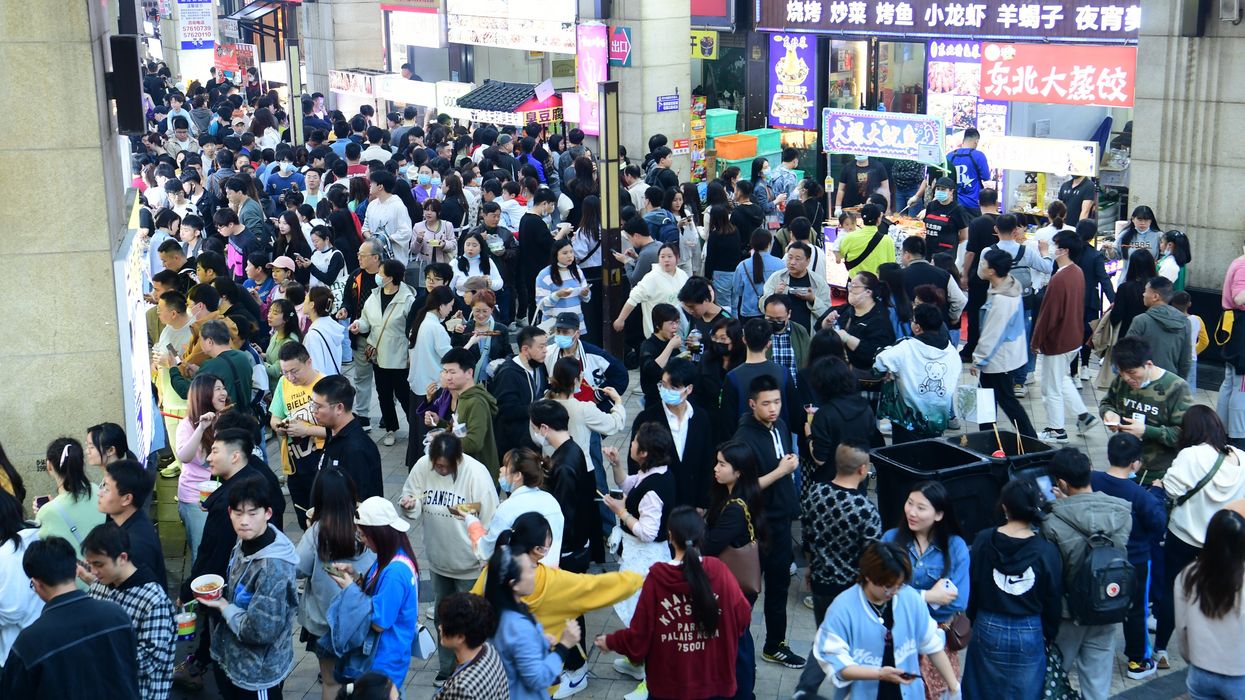 Visitors attend a night market in Shanghai, China