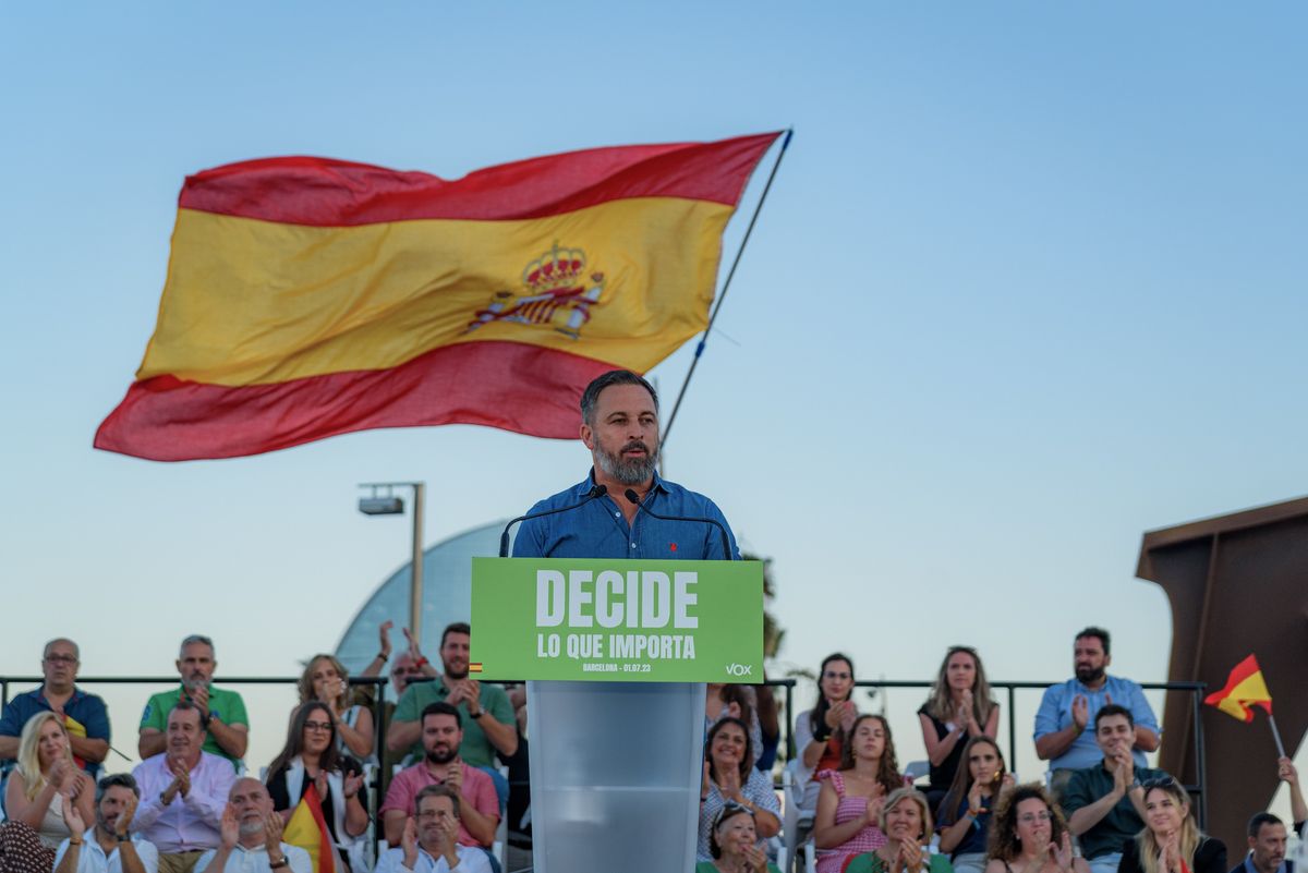 Vox leader Santiago Abascal speaks to the crowd with Spain's national flag in the background at a campaign stop in Barcelona.