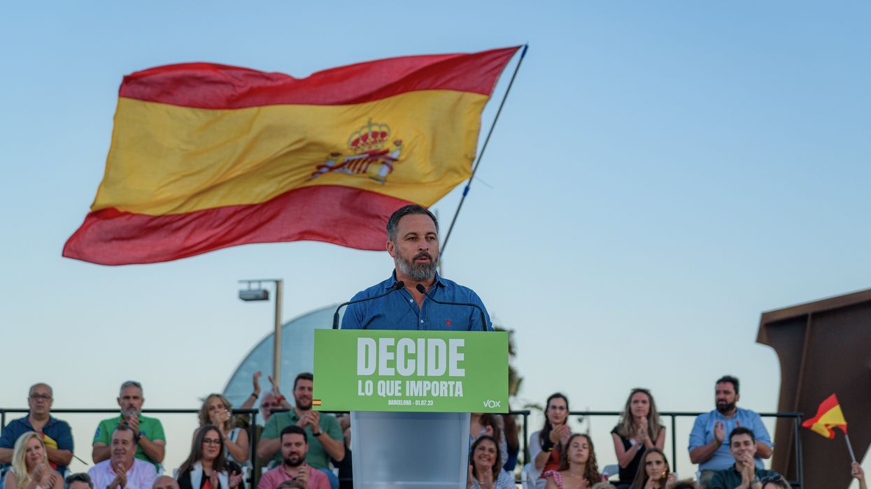 Vox leader Santiago Abascal speaks to the crowd with Spain's national flag in the background at a campaign stop in Barcelona.