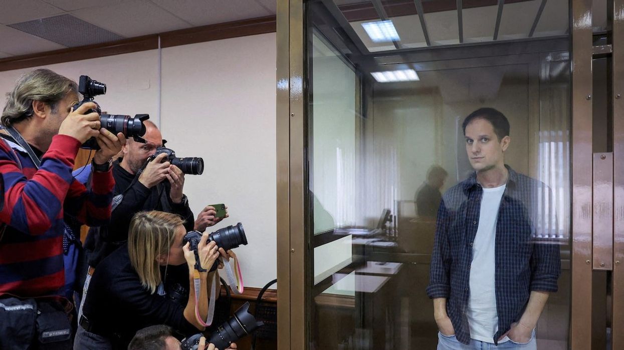 Wall Street Journal reporter Evan Gershkovich stands inside an enclosure for defendants before a court hearing to consider an appeal against his pre-trial detention on espionage charges in Moscow, Russia, October 10, 2023.