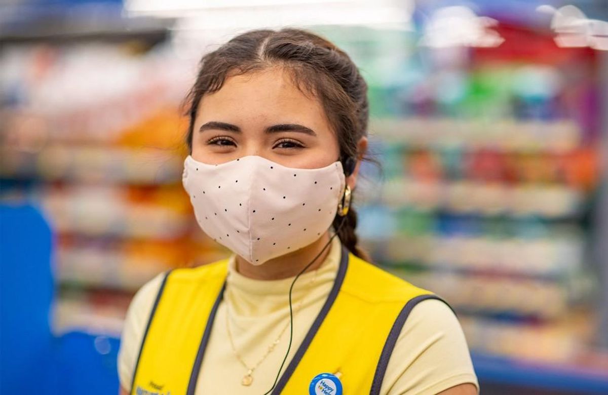 Walmart employee looking at camera, wearing a mask