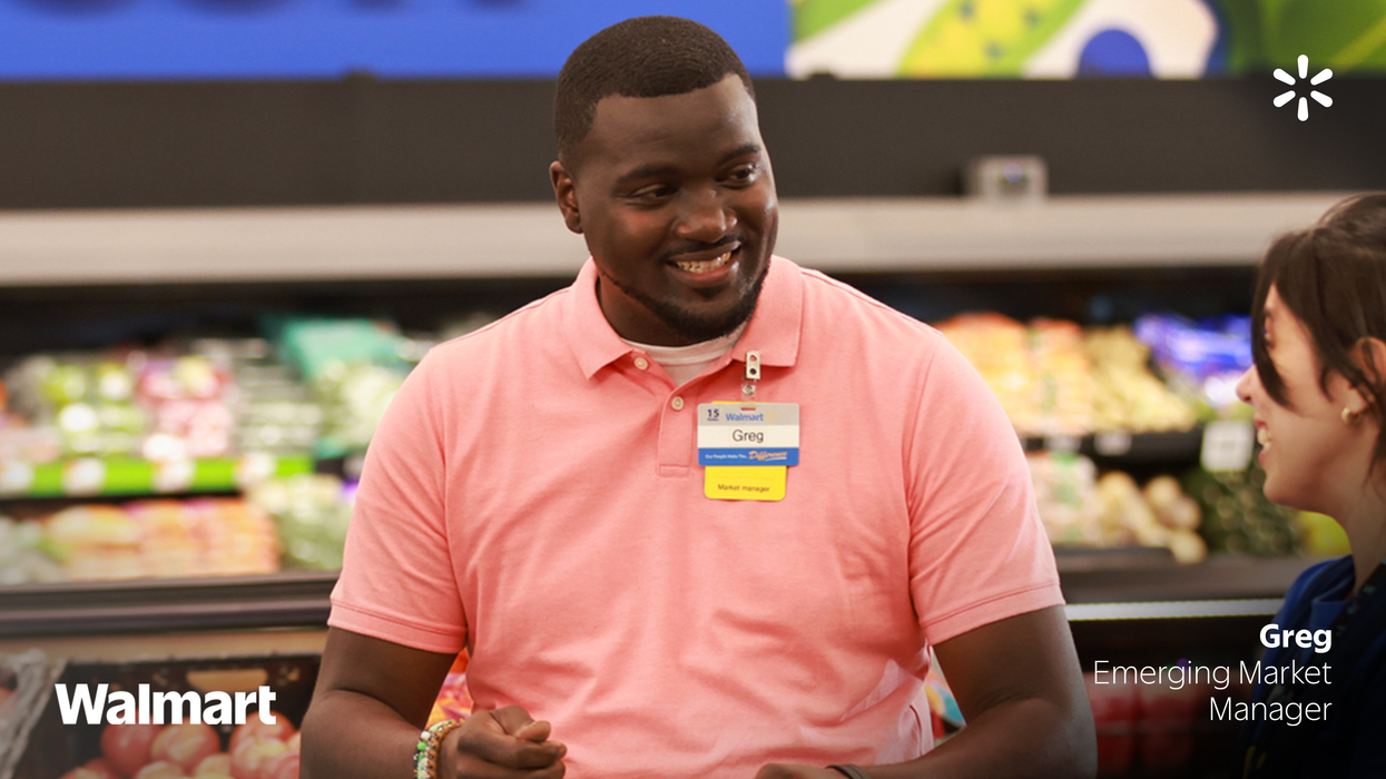 Walmart employee taking to another person at a Walmart store