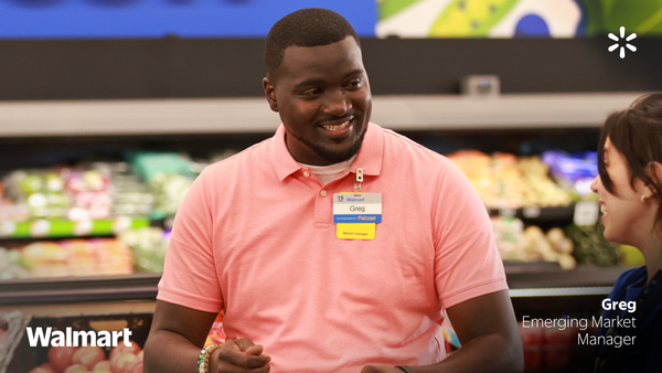 Walmart employee taking to another person at a Walmart store