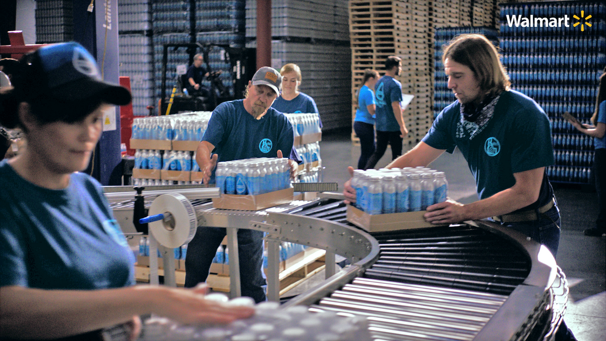 Walmart employees working in a water packaging facility 