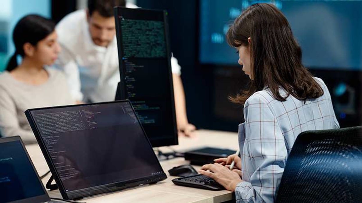 Woman on her desk typing on the keyboard at her work