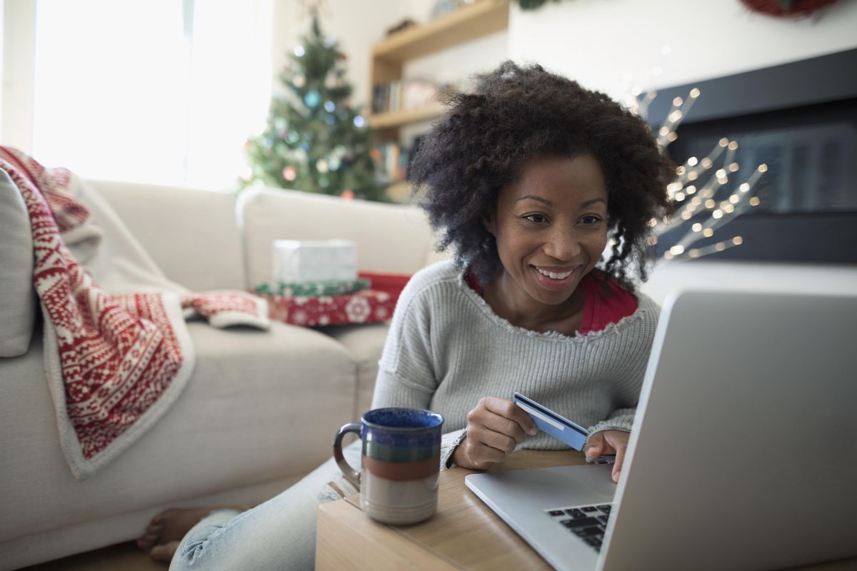 Woman shopping online in her living room during the holiday season.