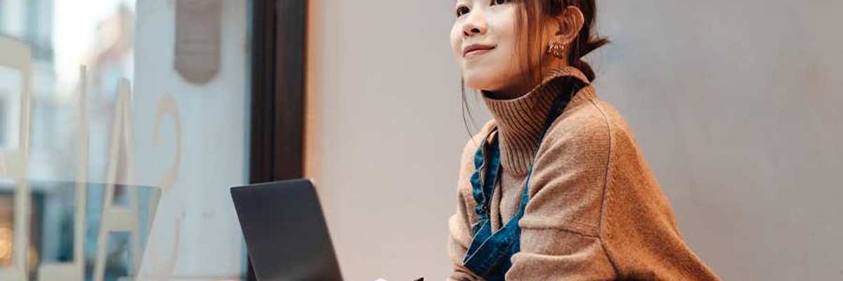 Woman working with a laptop in front of her