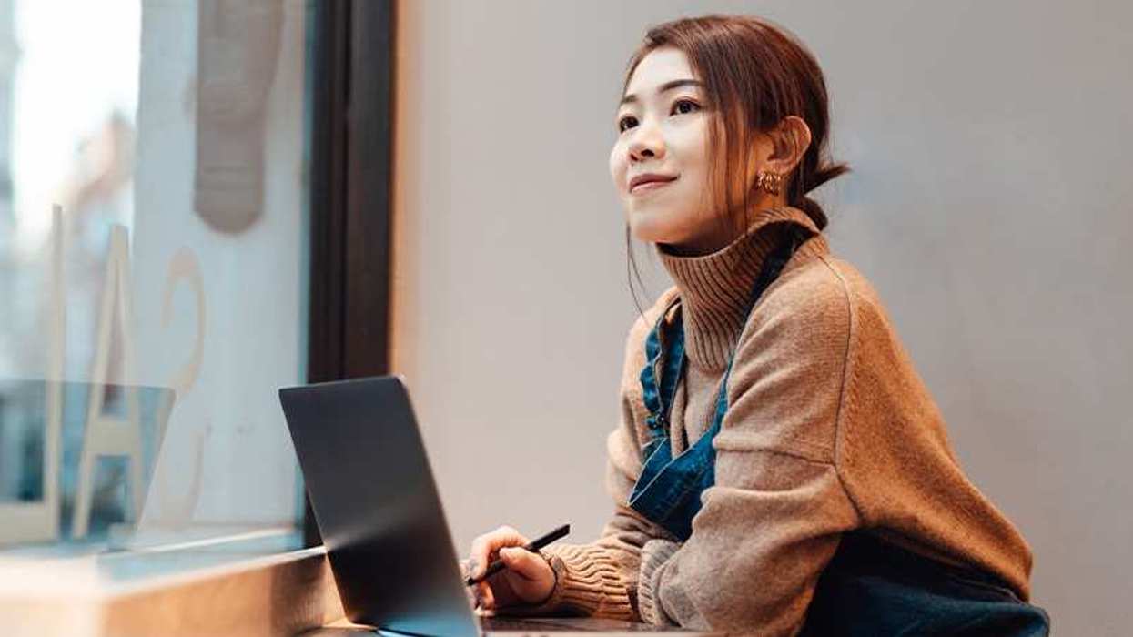 Woman working with a laptop in front of her