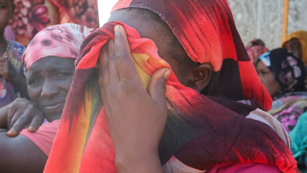 Women from the city of Al-Junina (West Darfur) cry after receiving the news about the death of their relatives as they waited for them in Chad, Nov. 7, 2023.
