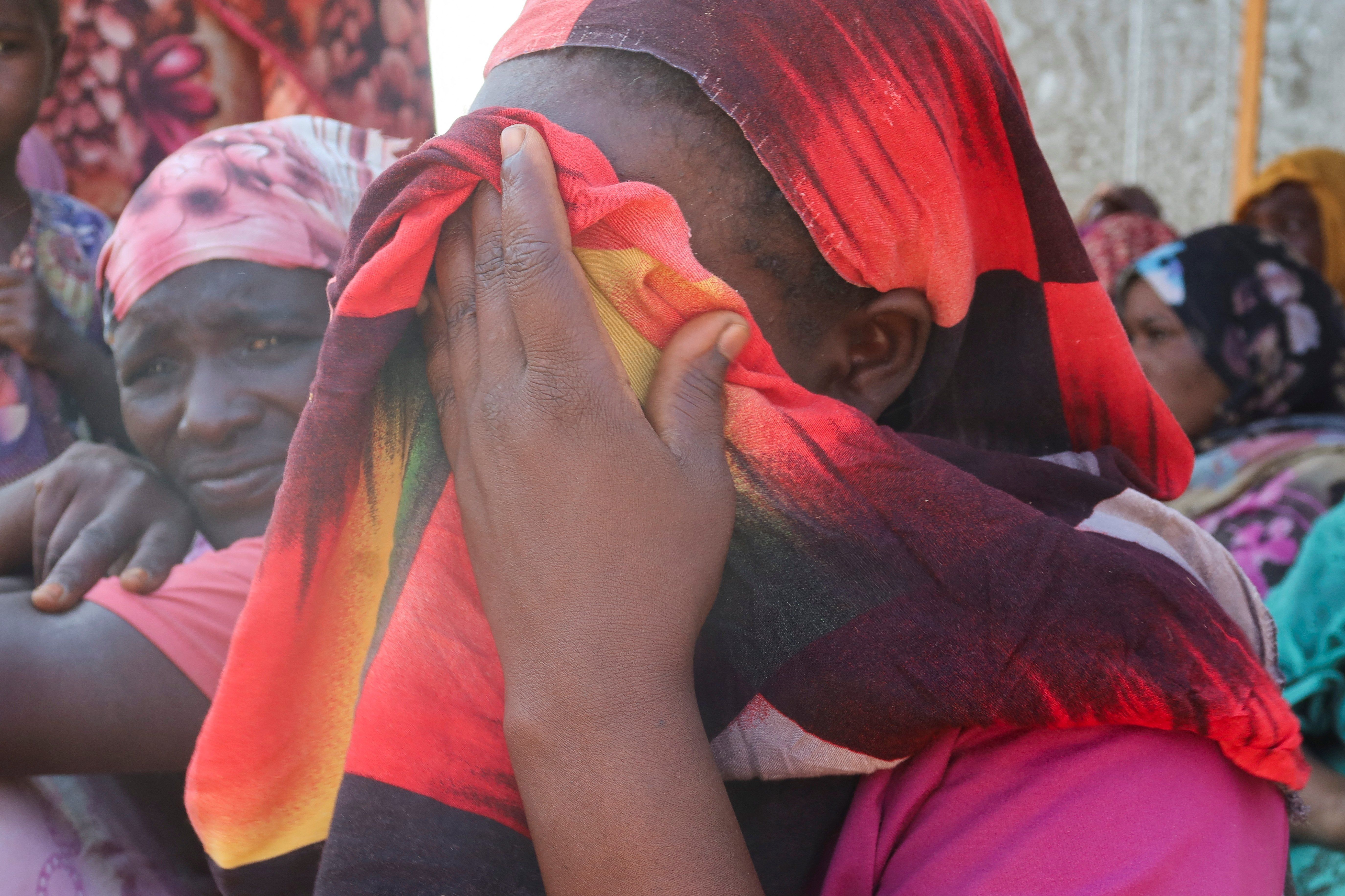 ​Women from the city of Al-Junina (West Darfur) cry after receiving the news about the death of their relatives as they waited for them in Chad, Nov. 7, 2023. 