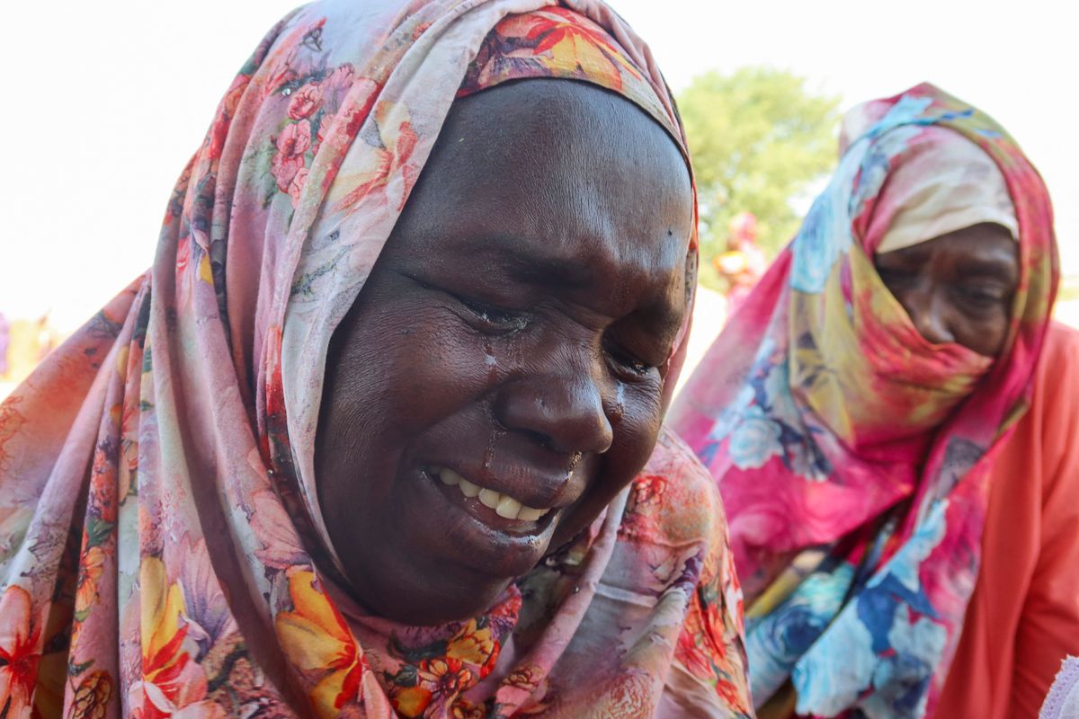 Women from the city of Al-Junina (West Darfur) cry after receiving the news about the death of their relatives as they waited for them in Chad, November 7, 2023.