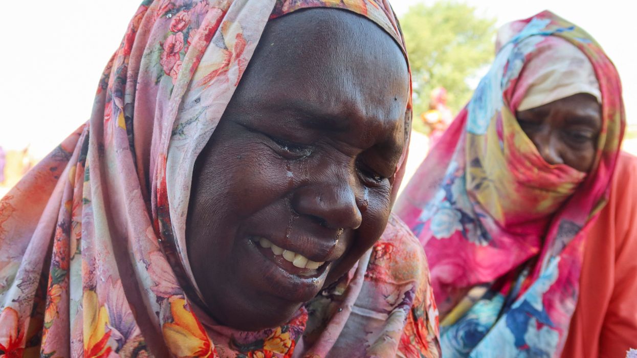 Women from the city of Al-Junina (West Darfur) cry after receiving the news about the death of their relatives as they waited for them in Chad, November 7, 2023.
