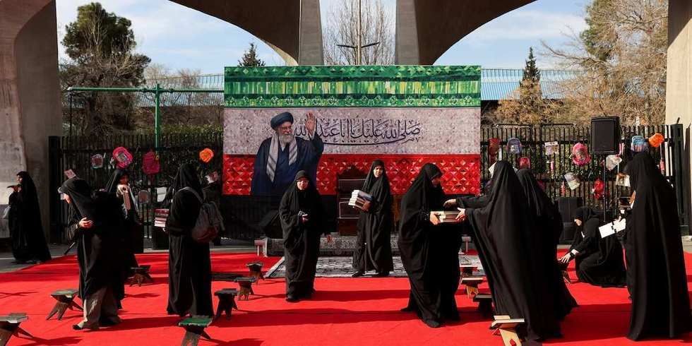 ​Women prepare a makeshift memorial in tribute to Iran's late Supreme Leader Ayatollah Ali Khamenei on a street, after he was killed in Israeli and U.S. strikes on Saturday, amid the U.S.-Israeli conflict with Iran, in Tehran, Iran, March 4, 2026. 