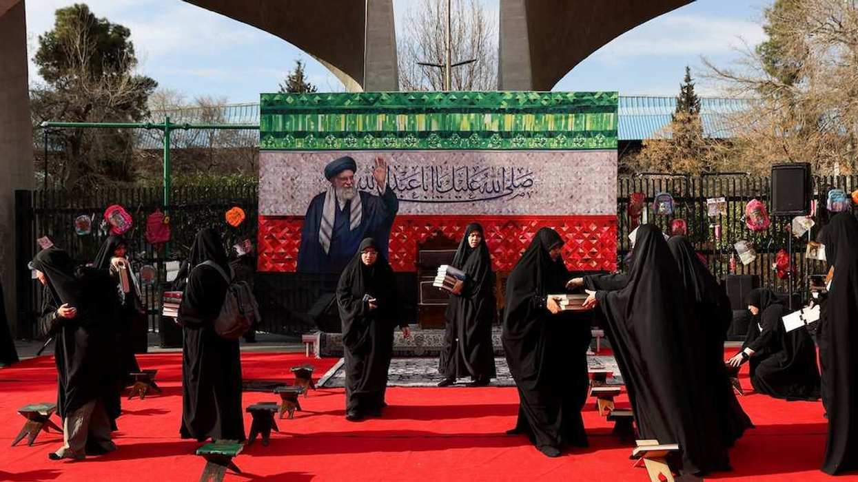 Women prepare a makeshift memorial in tribute to Iran's late Supreme Leader Ayatollah Ali Khamenei on a street, after he was killed in Israeli and U.S. strikes on Saturday, amid the U.S.-Israeli conflict with Iran, in Tehran, Iran, March 4, 2026.