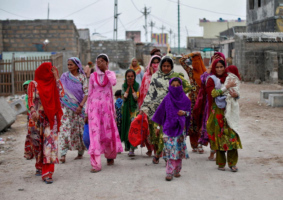 Women with their children leave their houses and evacuate to a safer place ahead of Cyclone Tauktae in Veraval in the western state of Gujarat, India, May 17, 2021.