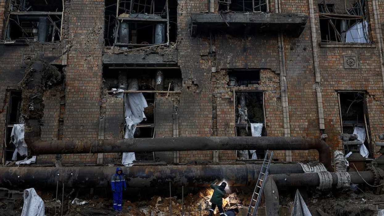 Workers repair a pipe at a compound of Darnytsia Thermal Power Plant which was heavily damaged by recent Russian missile and drone strikes, amid Russia's attack on Ukraine, in Kyiv, Ukraine February 4, 2026.