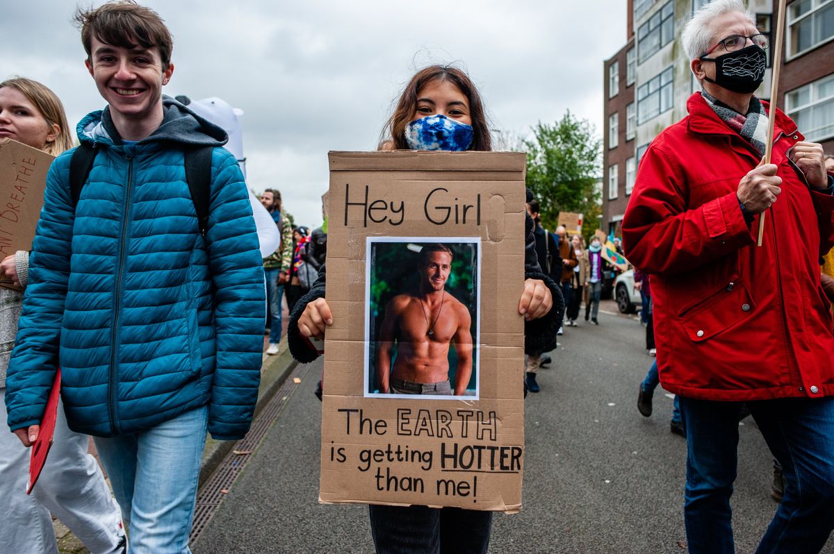 ​ Youth climate activists hold a sign of Ryan Gosling